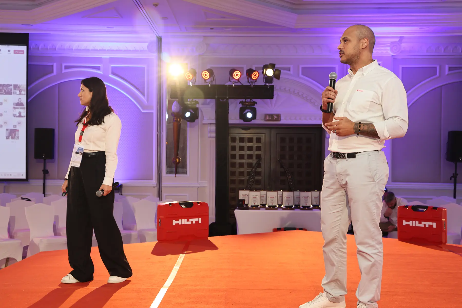Hilti presenters on a branded corporate stage
